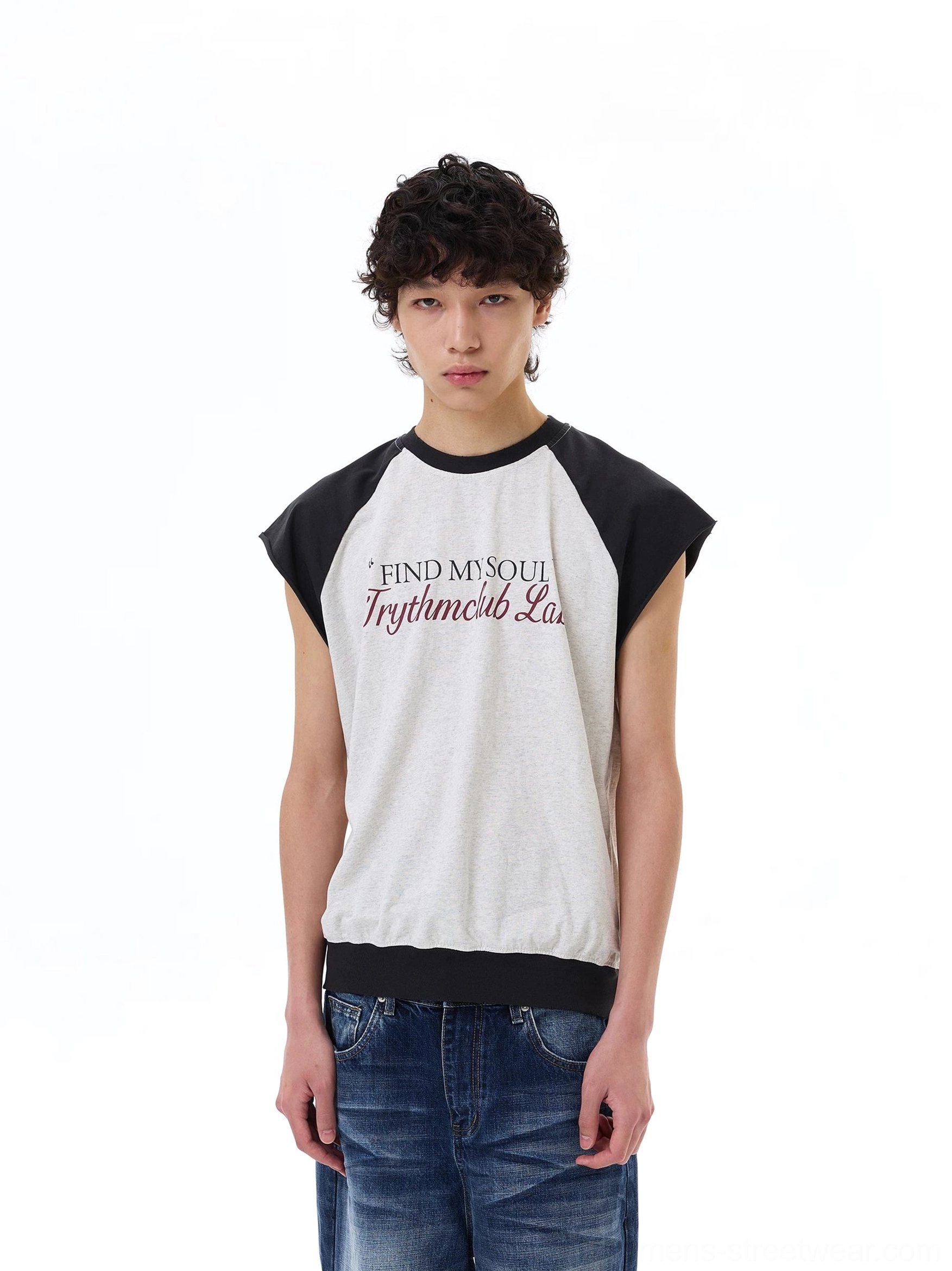Male model wearing light gray Find My Soul raglan cap-sleeve streetwear tee with medium wash baggy jeans, front view