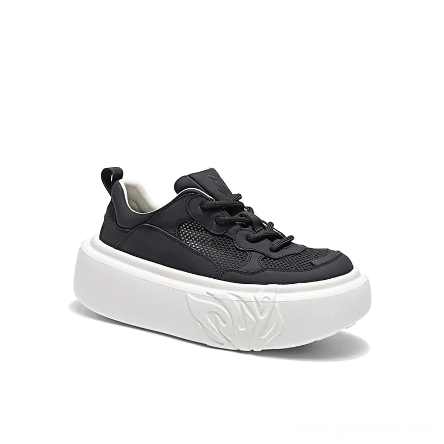 Black and white flame sole mesh platform sneakers in front three-quarter studio view