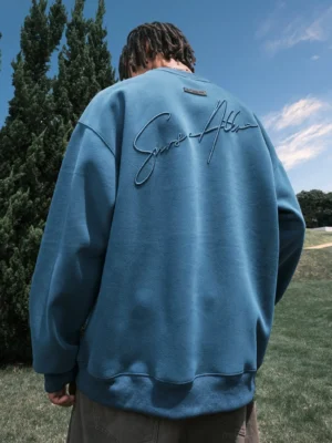 Royal blue oversized embroidered crewneck sweatshirt with cursive back graphic in outdoor streetwear look