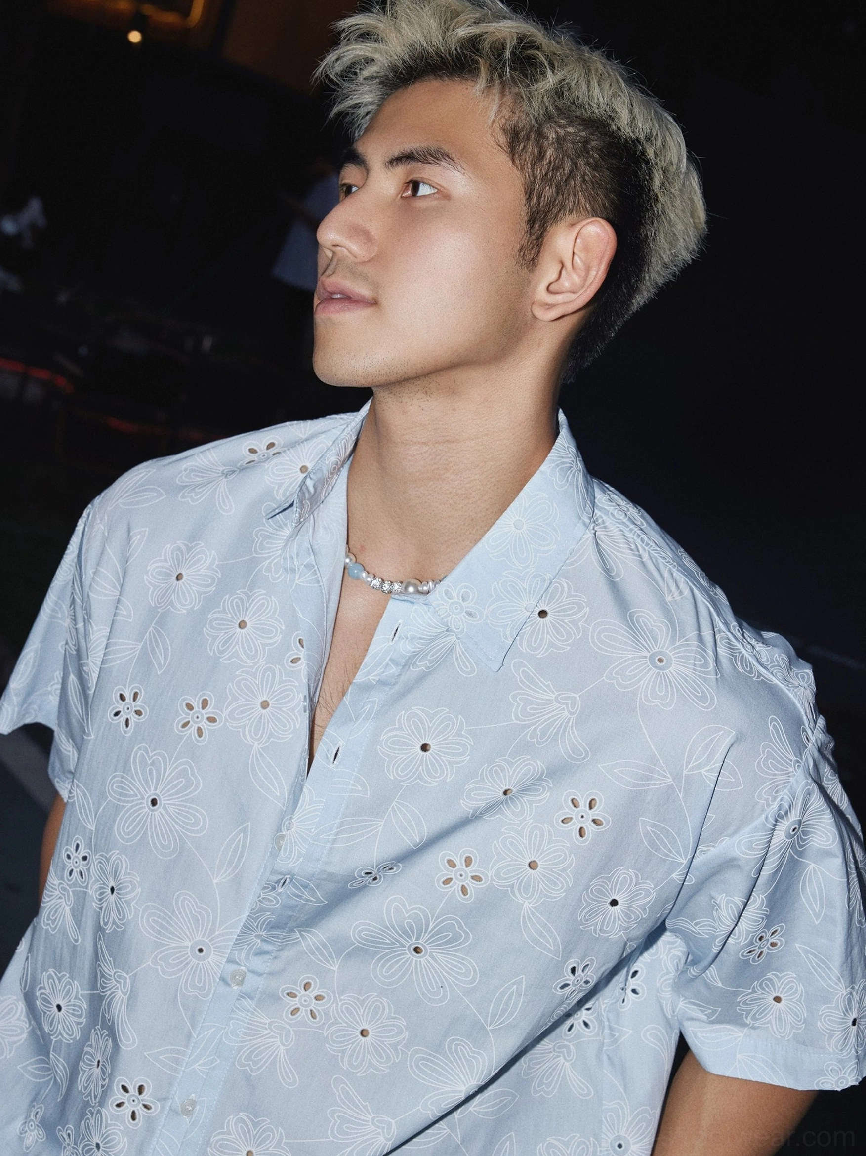Side close-up of the floral eyelet short sleeve shirt collar button placket and embroidered cutout details