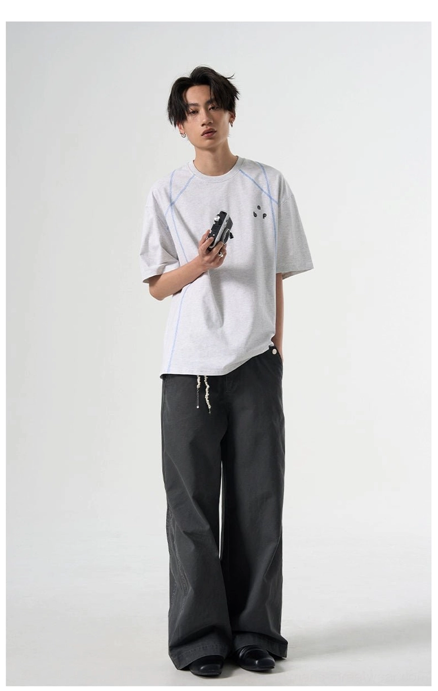 Flower Gray relaxed fit short sleeve T-shirt with blue seam detailing styled with dark wide-leg pants