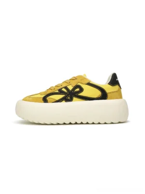 Yellow and black four-leaf motif chunky platform sneakers with wavy white rubber outsole side view