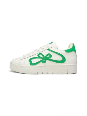 Green and white four-leaf clover bow chunky platform sneakers shown from the left side on a clean white background