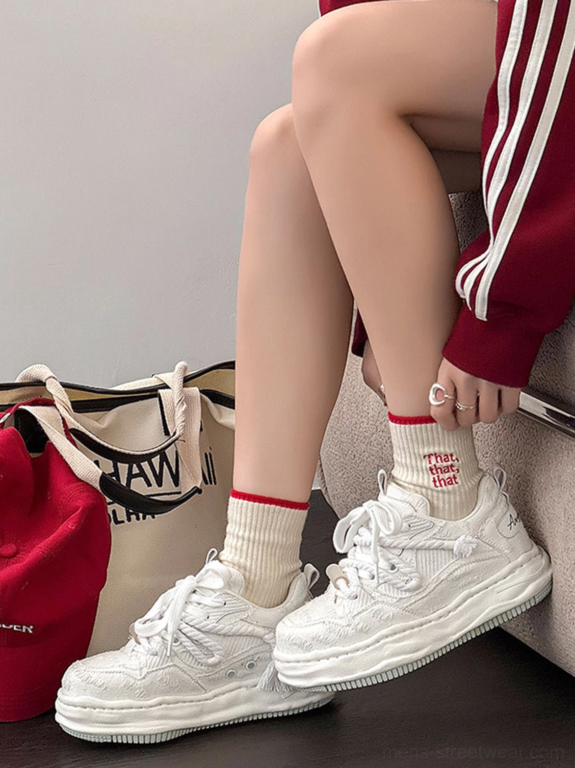 Three-quarter view of frayed canvas platform sneakers with chunky distorted soles worn with printed crew socks and casual Korean fashion