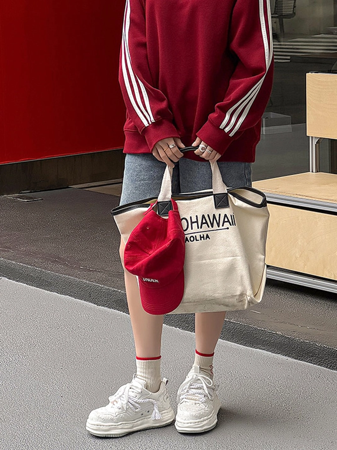 Light off-white frayed canvas platform sneakers worn with denim shorts, printed socks, red sweatshirt, and casual Seoul streetwear accessories
