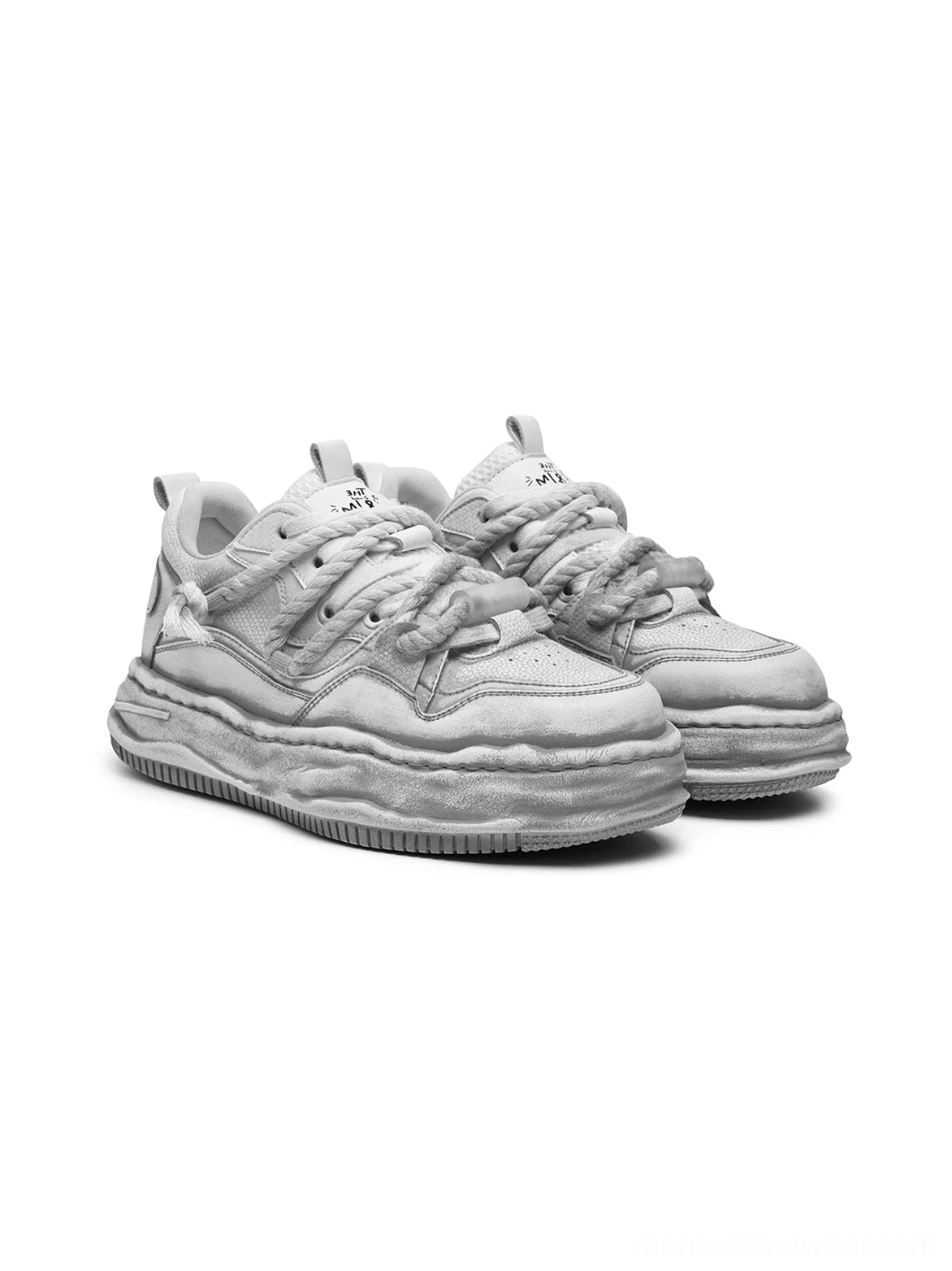 Front three-quarter product view of a pair of light off-white frayed canvas platform sneakers with twisted laces and thick wavy soles