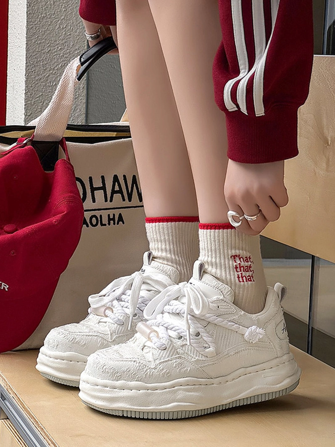 Light off-white frayed canvas platform sneakers styled with printed socks, red striped sweatshirt, canvas tote, and Seoul street fashion details