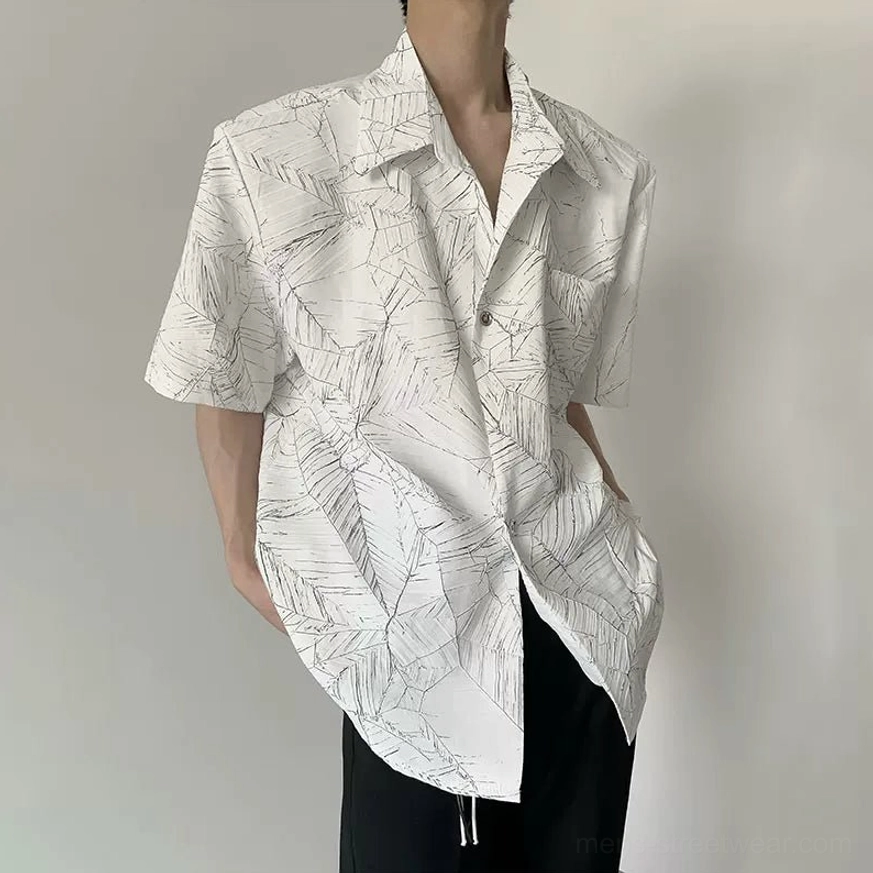 White oversized short sleeve leaf print shirt shown in a relaxed half-side streetwear view