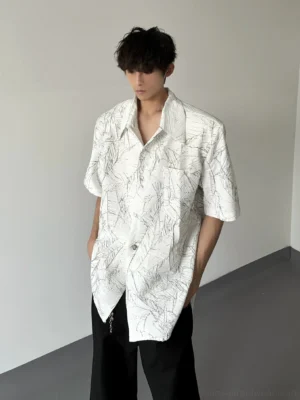 White oversized short sleeve leaf print shirt with curved hem styled with wide-leg black pants
