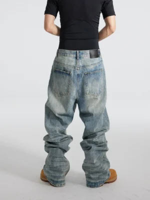 Rear view of distressed blue wide-leg streetwear jeans showing faded wash, classic back pockets, and stacked baggy legs