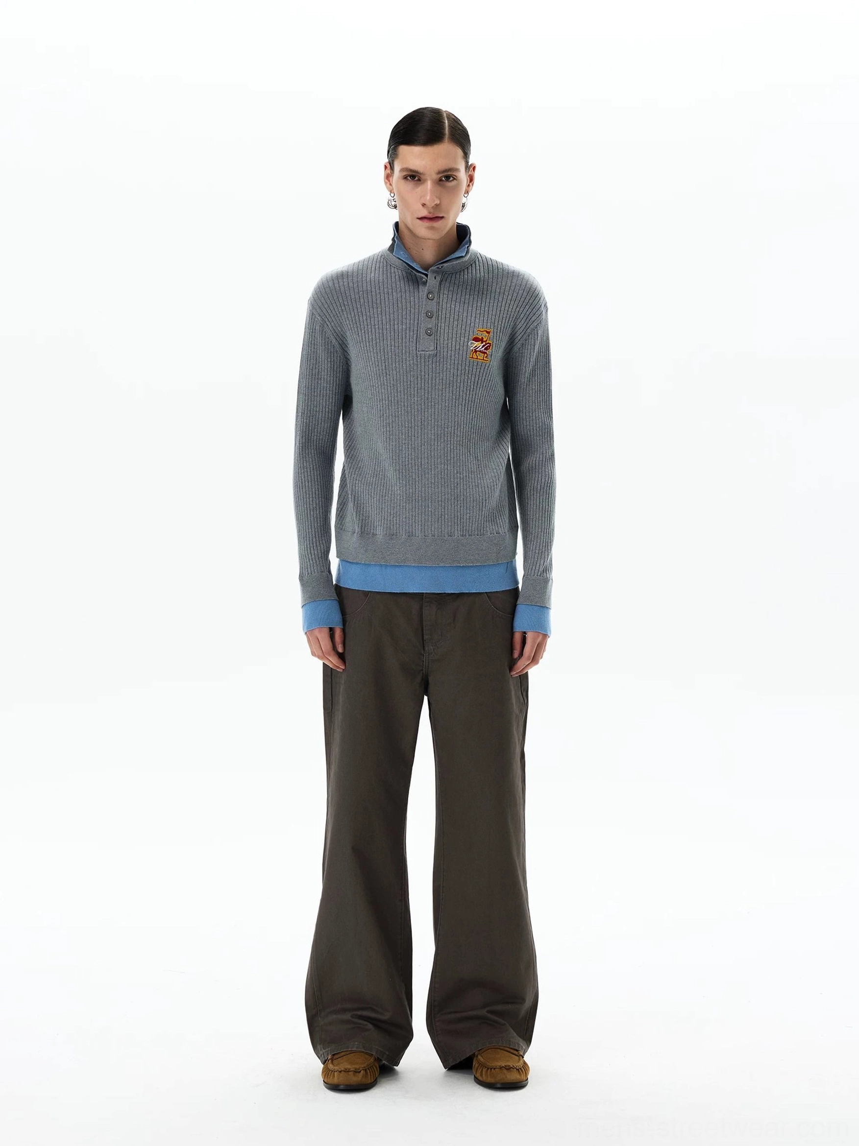 Front view of men's heather grey rib-knit half-button polo sweater with blue collar cuffs and layered hem detail