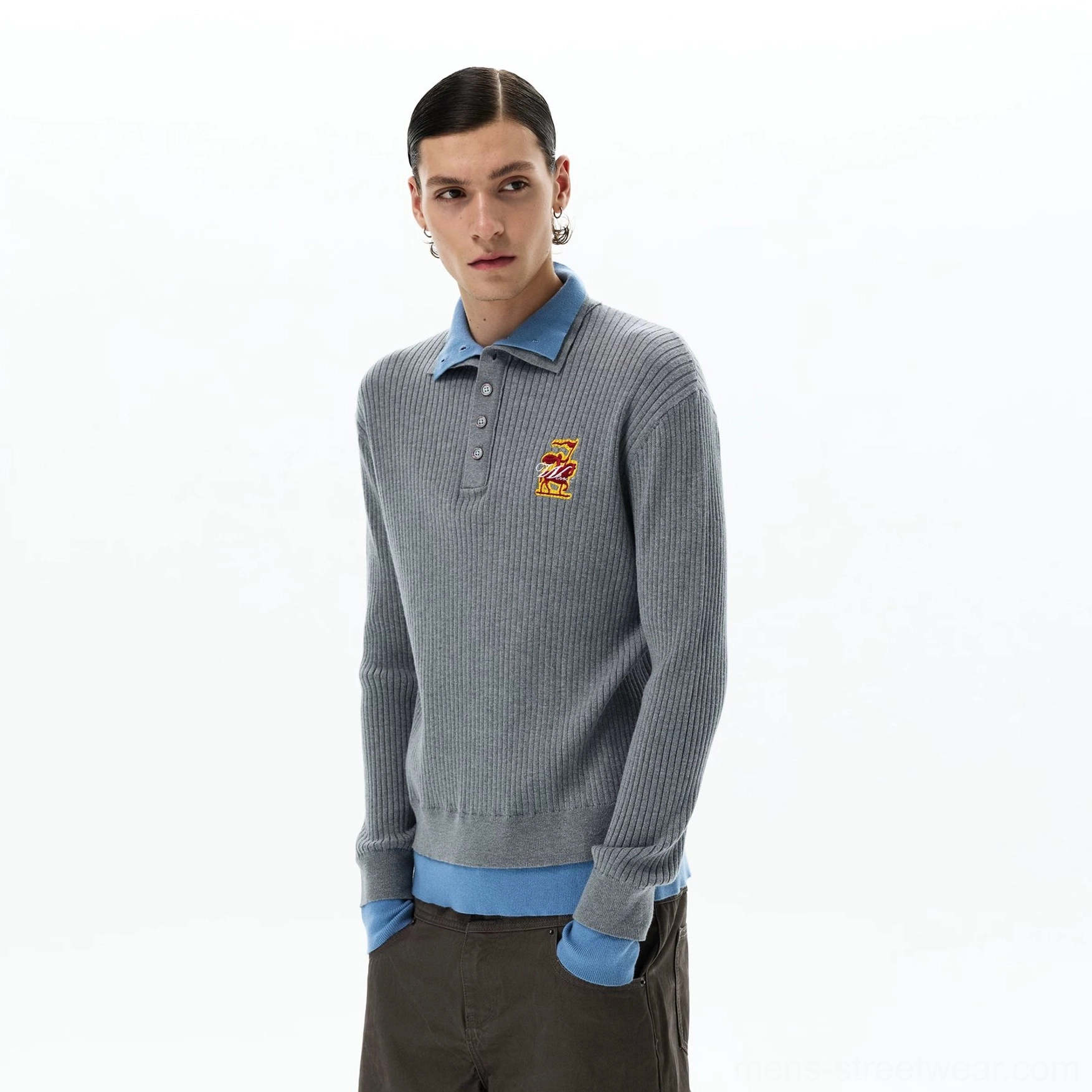 Close-up of men's grey layered rib knit polo sweater showing half-button collar embroidered chest crest and sky blue trim
