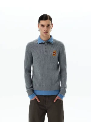 Men's heather grey layered rib knit polo sweater with sky blue collar cuffs and hem worn with brown wide-leg trousers front view