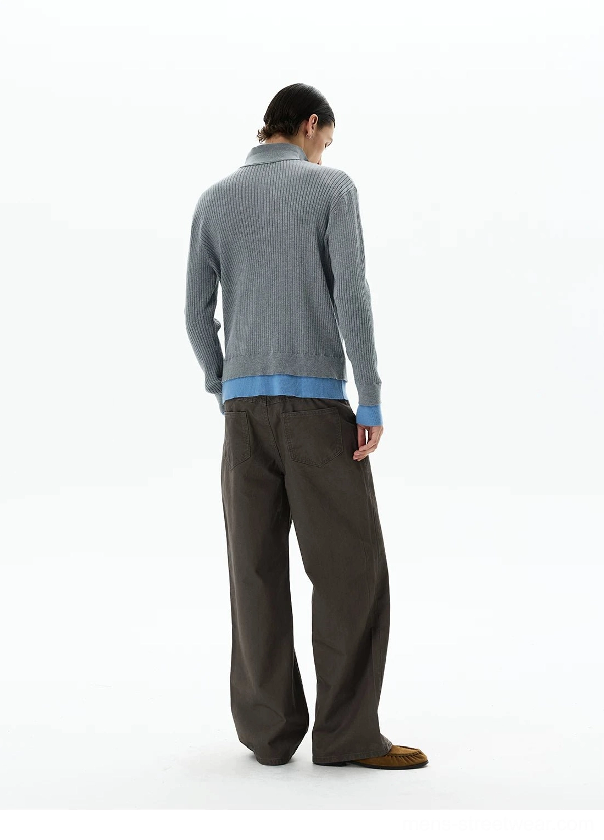 Rear three-quarter view of men's grey ribbed knit polo sweater with sky blue layered cuffs and contrast hem