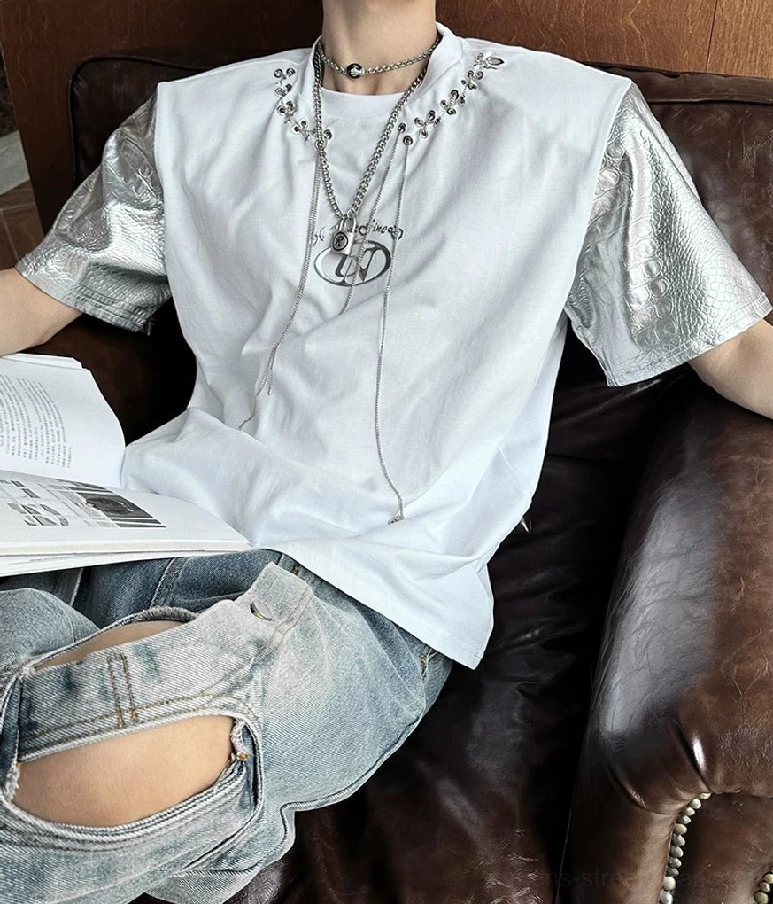 Futuristic paneled short-sleeve T-shirt with cotton body, faux-leather sleeves, metal eyelets, and draped chain laces