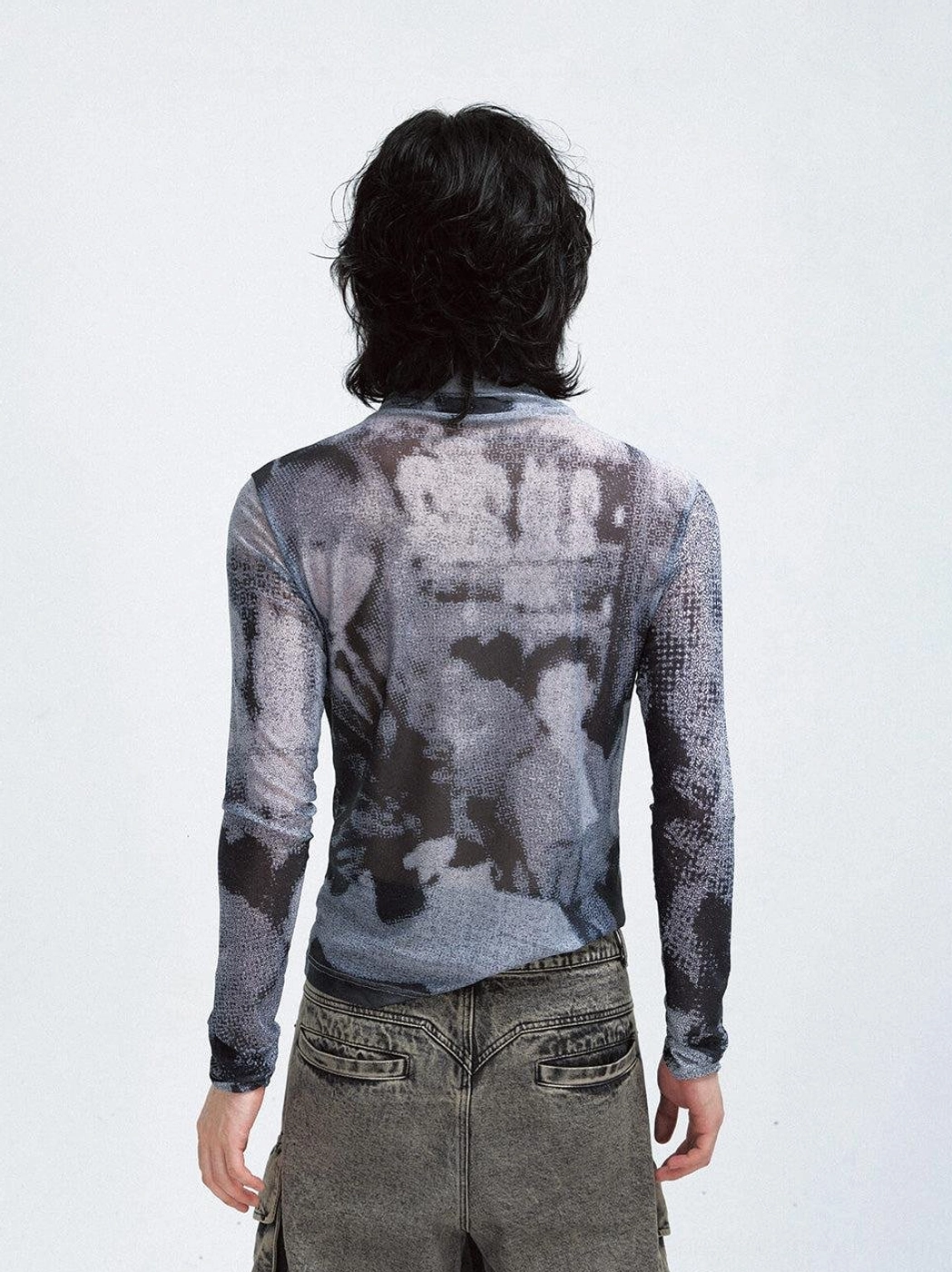 Back full-body view showing the printed design and slim fit of a black futuristic mesh turtleneck sweatshirt