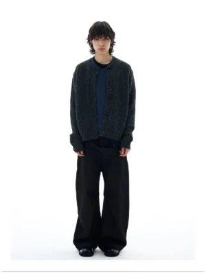 Dark gray fuzzy knit button cardigan worn with navy top and black wide-leg trousers in full front streetwear outfit