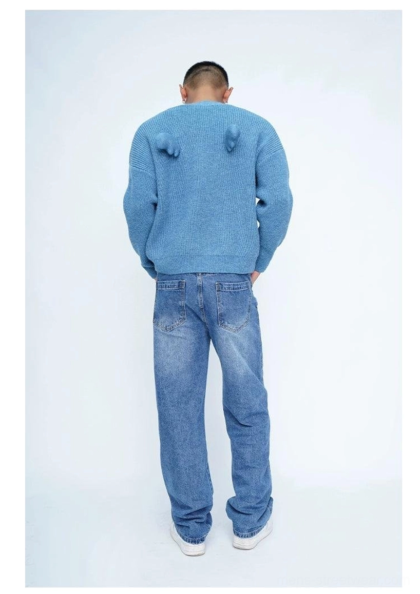 Fuzzy oversized cardigan featuring ribbed knit texture, V-neck button front, and playful decorative pom-pom details