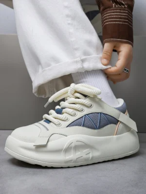 Blue and off-white platform runner sneaker worn with cropped white jeans showing the cushioned chunky sole