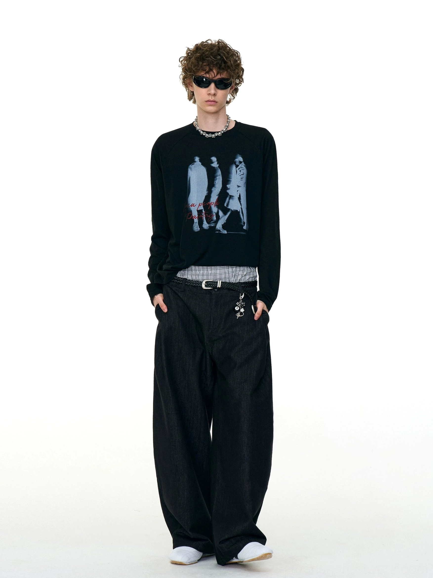 Full body model wearing a black Ghost Walkers graphic long sleeve tee with red script, wide-leg pants, and Seoul streetwear styling