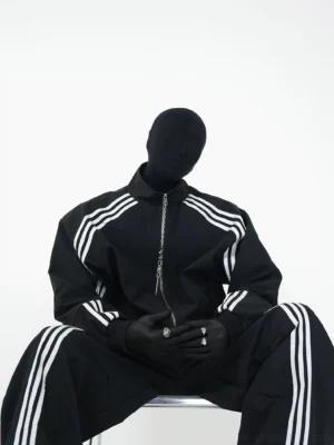 Ghostline black triple stripe oversized track suit set front sitting view with stand collar zip jacket and wide leg pants