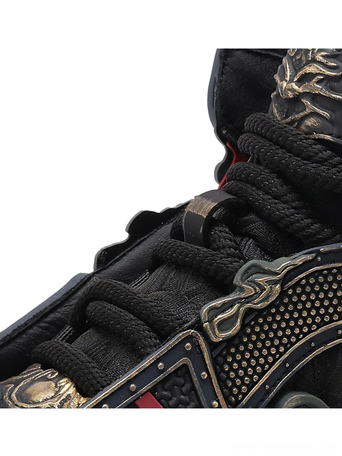 Close-up of black high-top sneaker upper showing thick laces, metal-look buckles, rivet texture, and mixed material craftsmanship