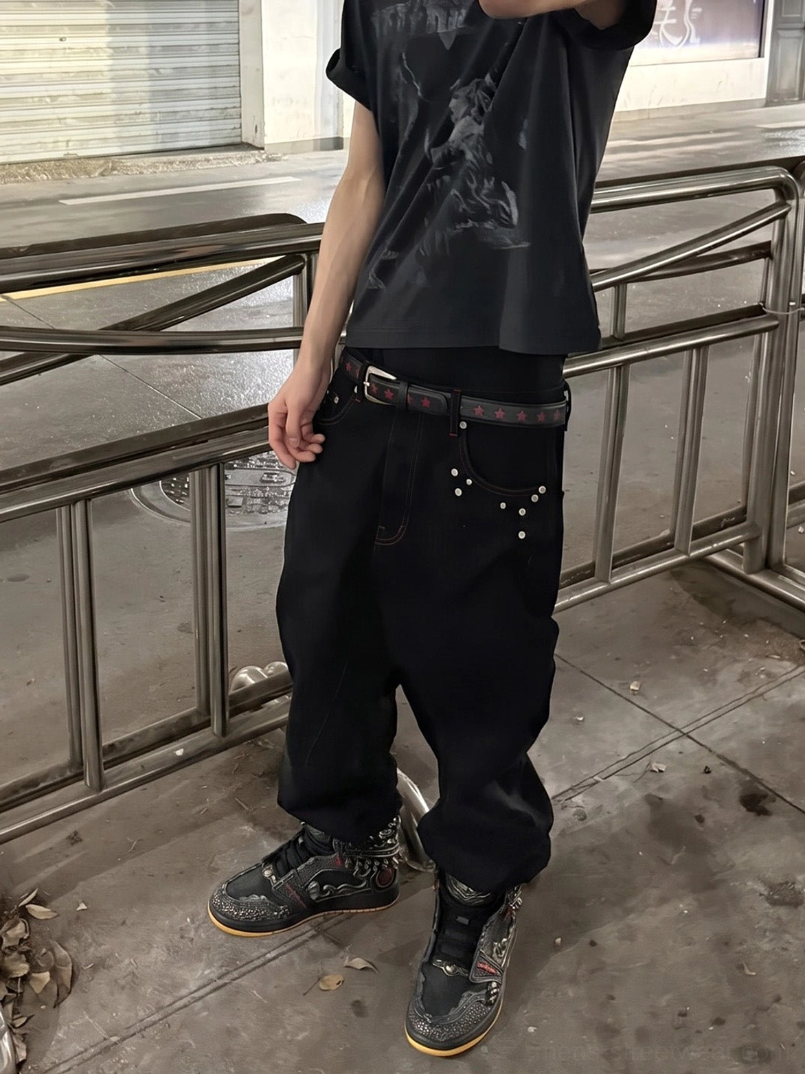 Gilded mythic armor high-top sneakers styled with baggy dark streetwear pants in an urban street setting