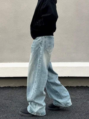 Side profile of glacier drift light wash super wide baggy jeans with vintage faded denim and relaxed streetwear fit