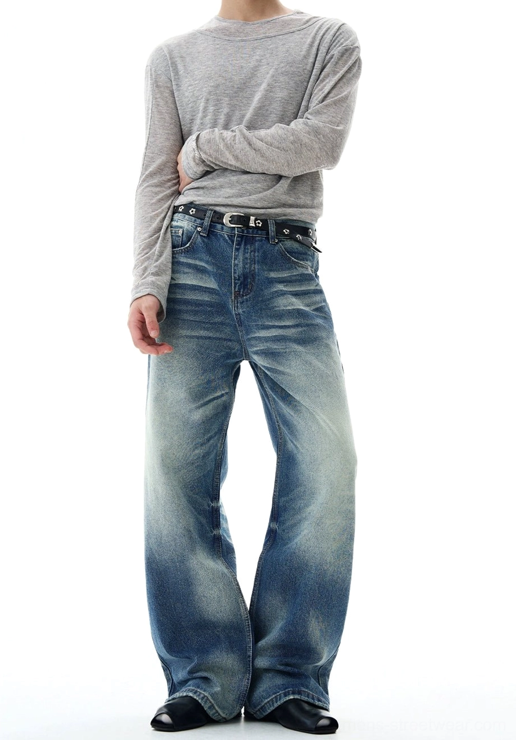 Front view of glacier fade flare-leg jeans showing the zipper fly, belt loops, five-pocket construction, vintage crease fading, and oversized bell-bottom legs