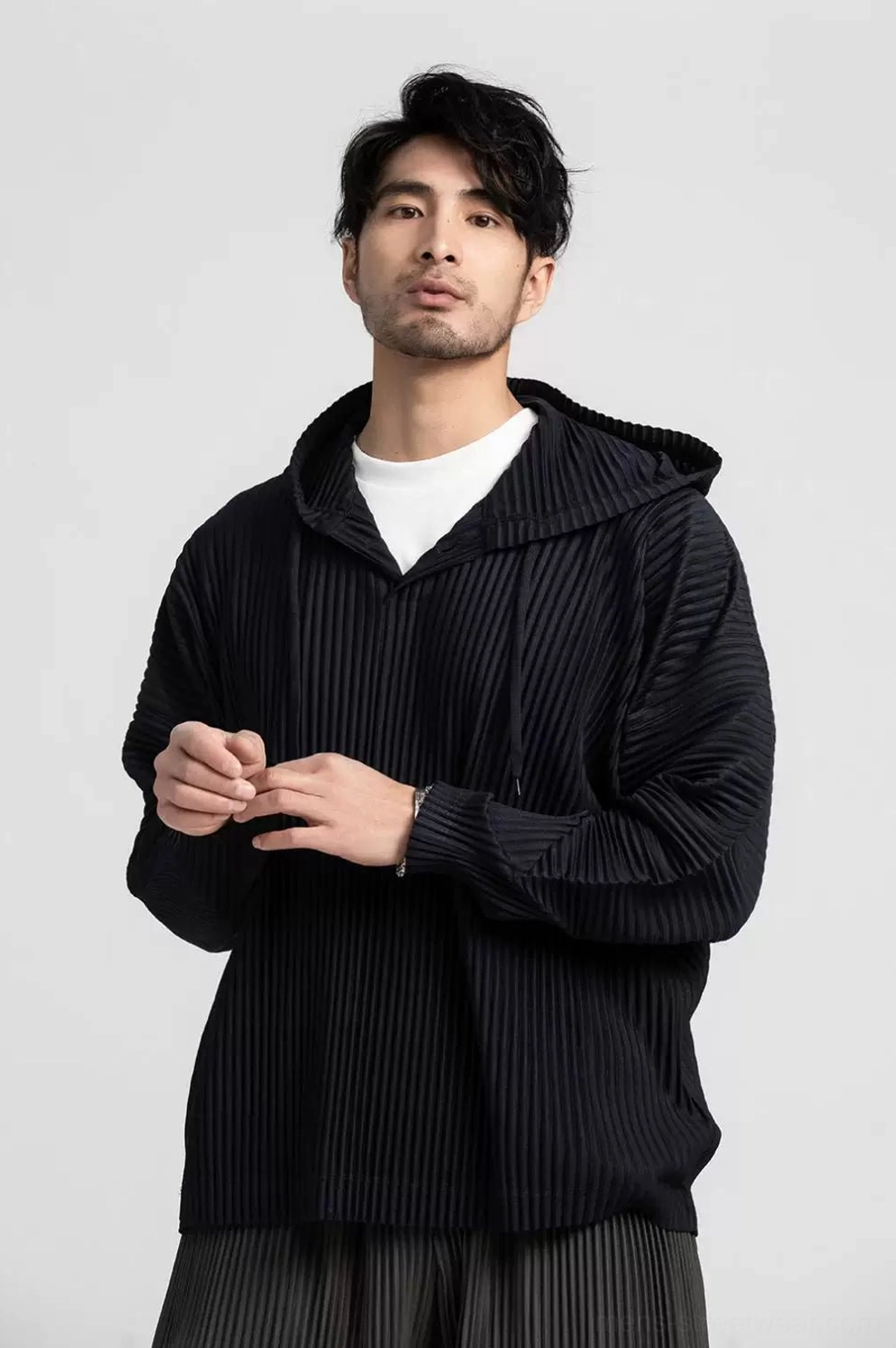 Black oversized Glacier Wave pleated hoodie and pants set shown in a front close-up with vertical texture and adjustable hood