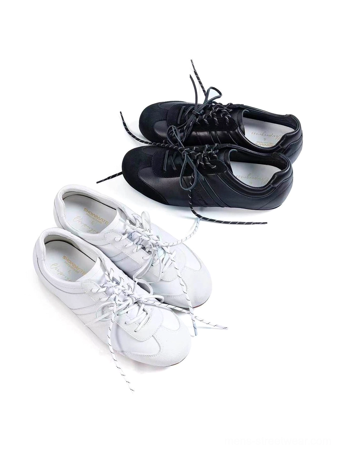 Black and white low-profile suede leather retro trainers arranged together in a clean overhead product display