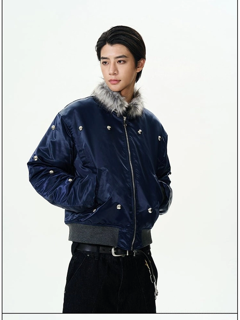 Right three-quarter view of a glossy navy streetwear bomber jacket with ribbed waistband faux fur collar and silver studs