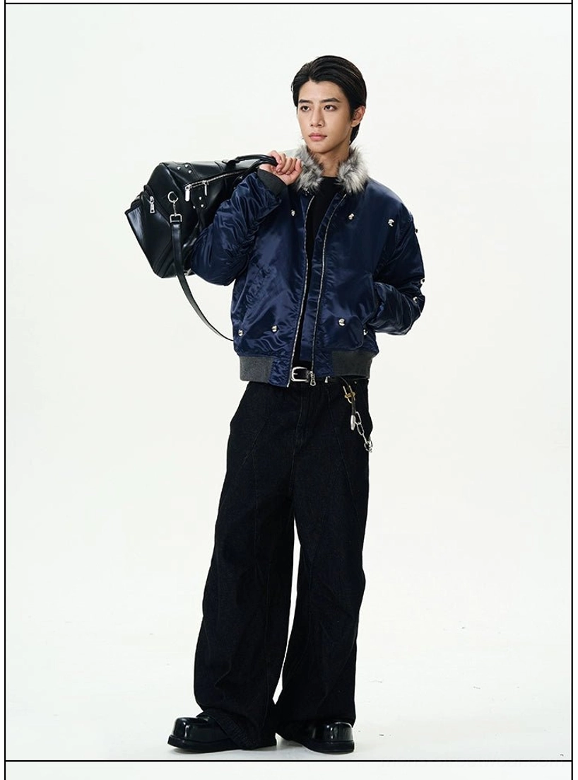 Half-body side view showing the glossy navy fabric silver stud details and faux fur collar of a streetwear bomber jacket