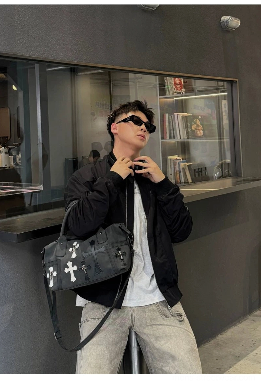 Black gothic crossbody satchel worn with sunglasses and casual Korean streetwear outfit indoors