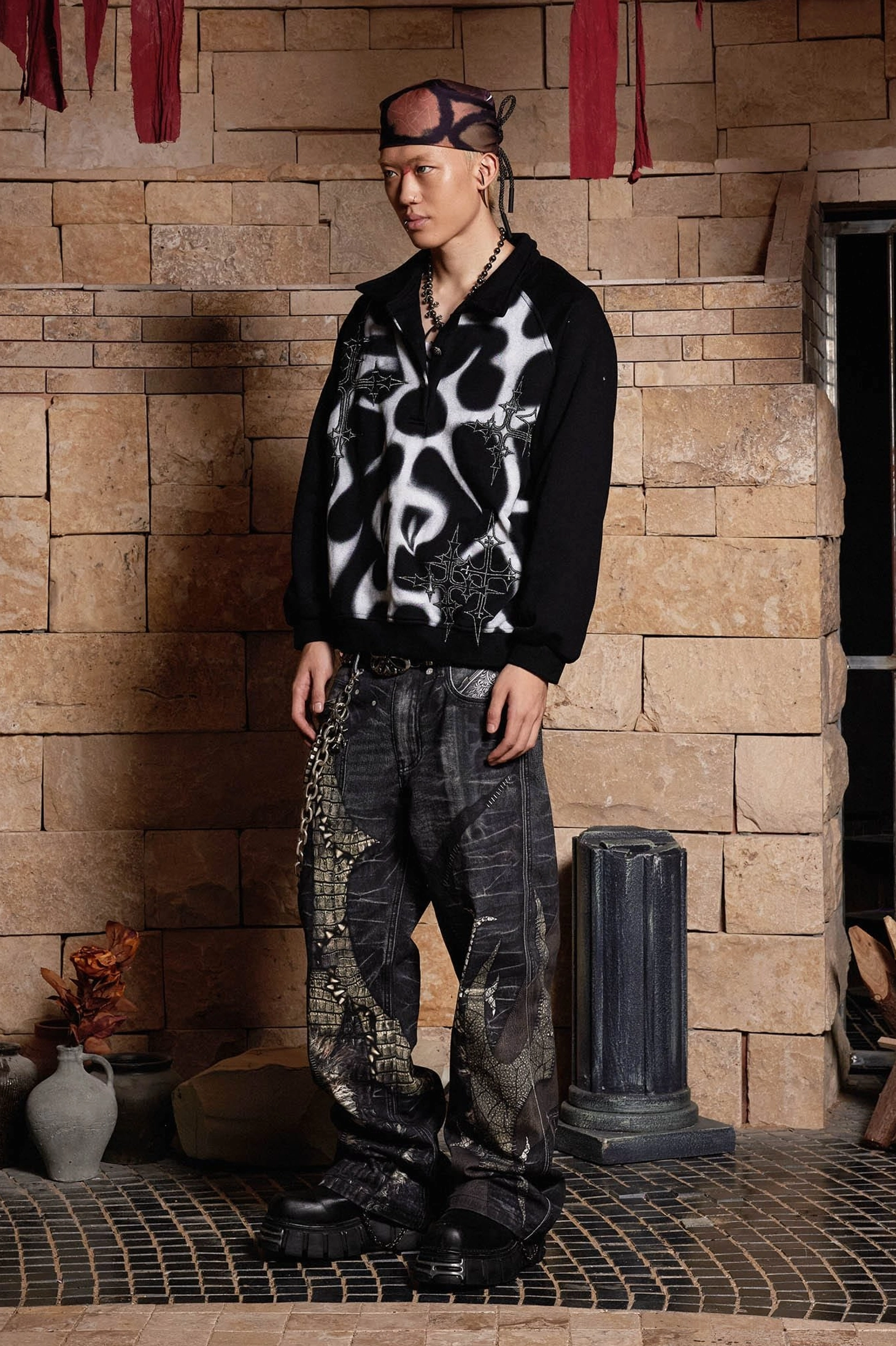 Gothic dragon sword graphic jeans styled with a dark hoodie, featuring washed denim, chain accents, studded belt, and loose wide-leg cut
