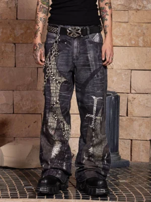 Front view of washed dark grey gothic dragon sword wide-leg jeans with crocodile-inspired graphics, metal chains, studded belt, and baggy streetwear fit