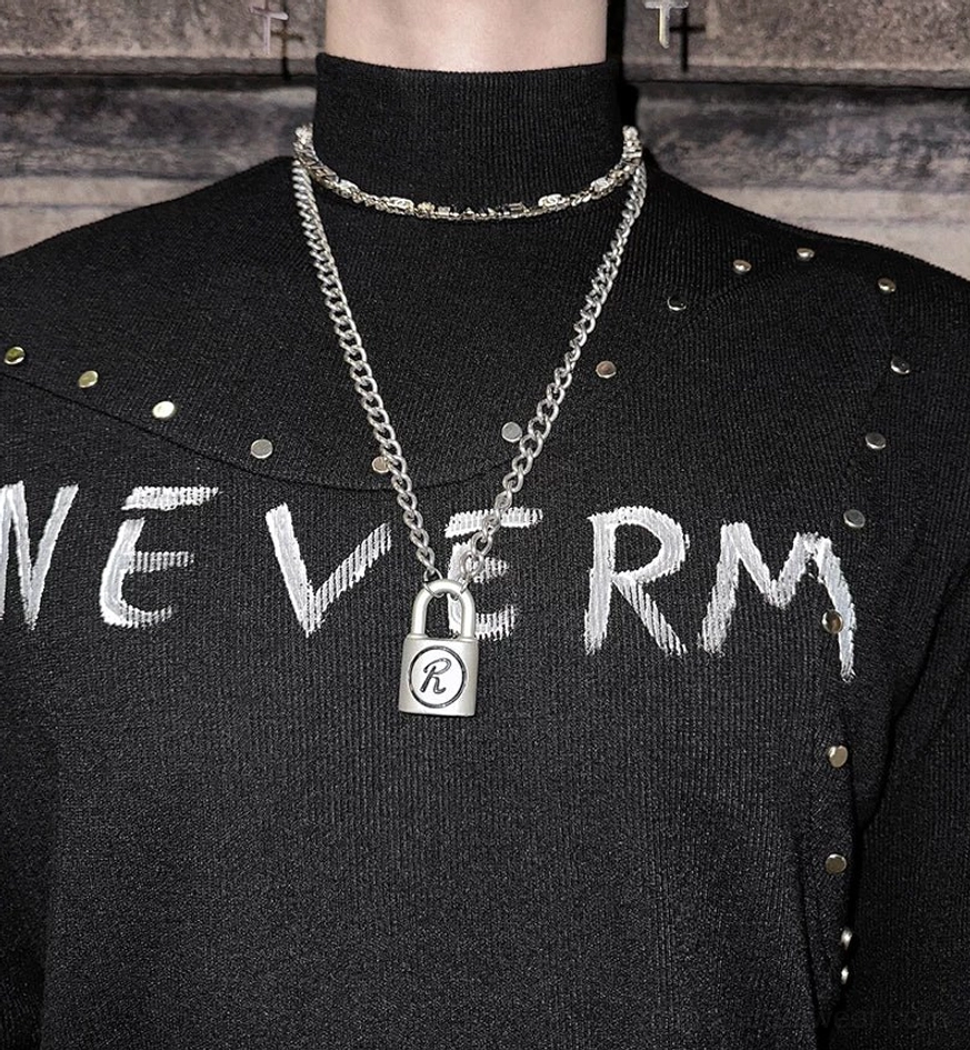 Gothic knit turtleneck sweater with studded collar, distressed graphic chest print, and fitted long sleeve streetwear design