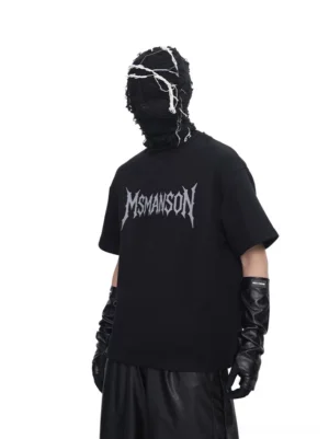 Back view of black oversized gothic script graphic T-shirt styled with wide-leg pants and leather gloves in a dark Korean streetwear look