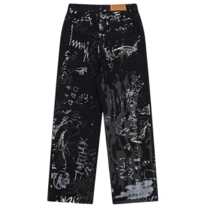 Back view of graffiti-print wide-leg jeans with leather brand tag and full coverage hand-drawn graffiti artwork on rear patch pockets