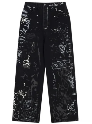 Graffiti print wide-leg black jeans front flat lay view showing all-over hand-drawn artwork and splatter ink designs on premium denim streetwear