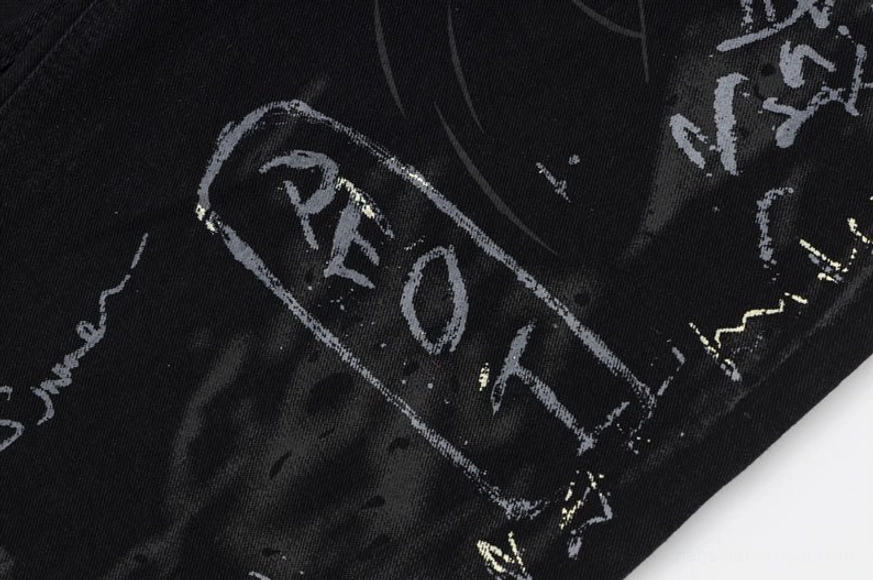 Graffiti-print wide-leg black denim jeans styling detail showing fabric texture quality and full artwork coverage for streetwear fashion