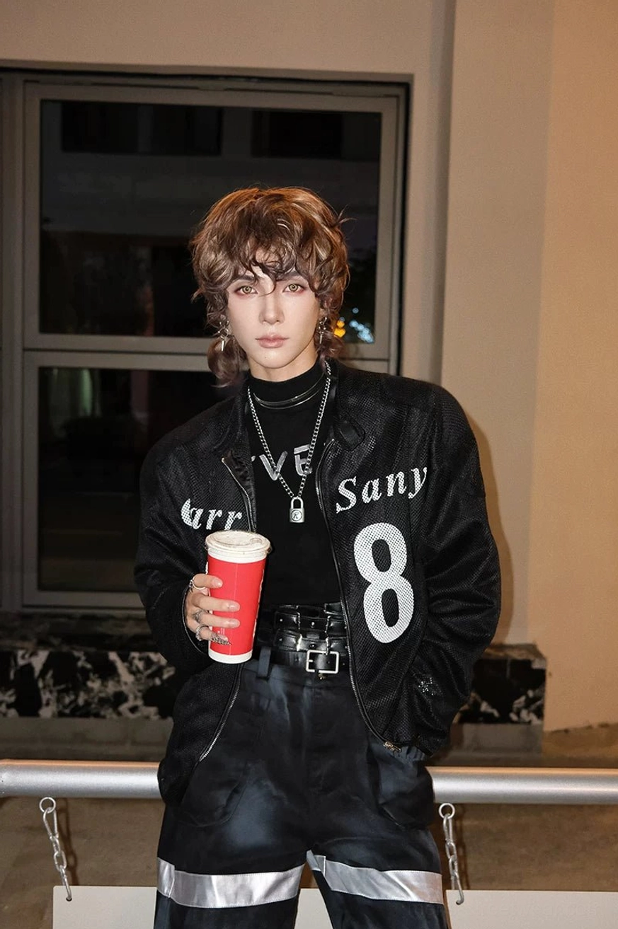 Graphic gothic streetwear outfit featuring a fitted mock turtleneck inner layer, printed moto jacket, cargo pants, leather belt, and layered silver necklaces