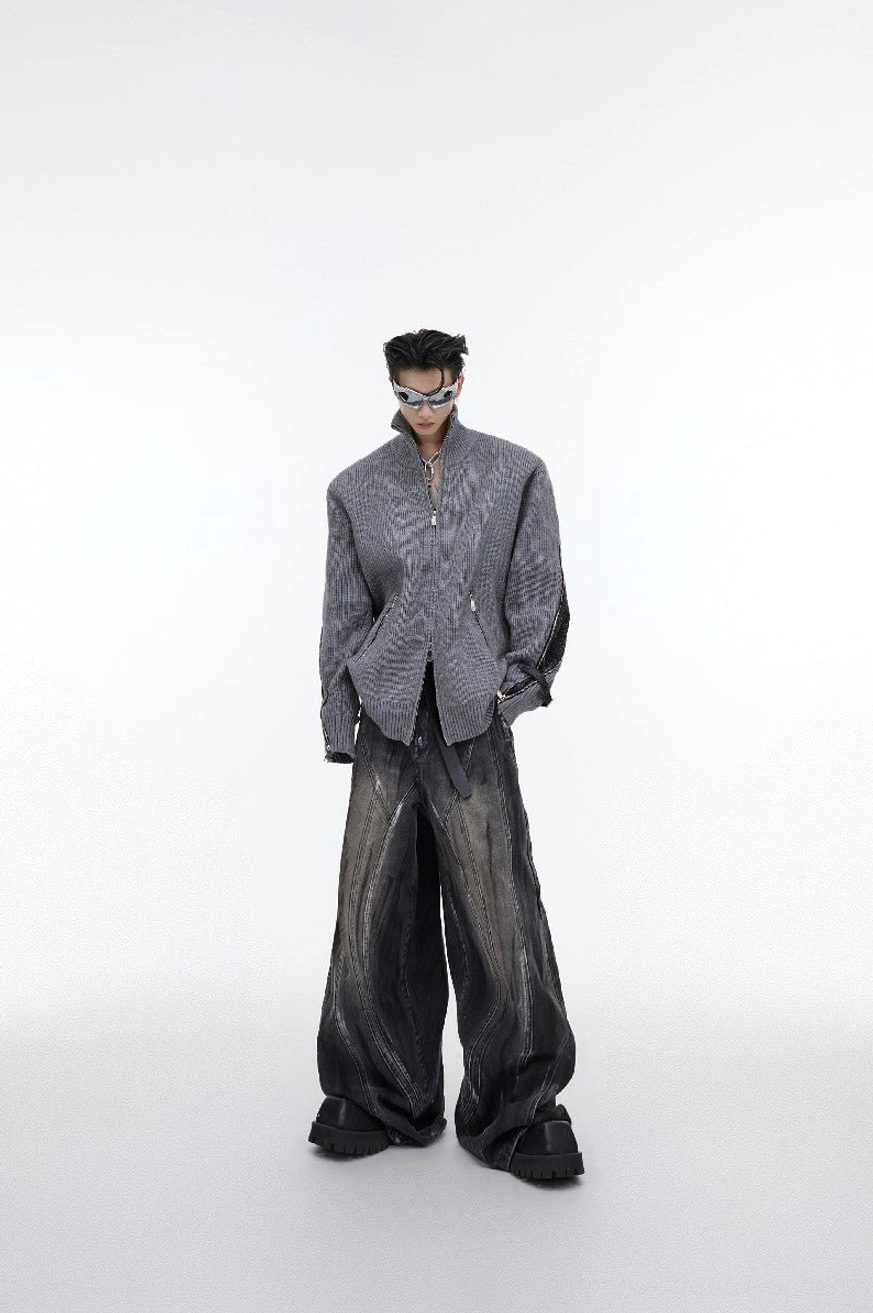 Graphite black washed distressed flared denim jeans styled with an oversized gray blazer sunglasses and contemporary Seoul streetwear accessories