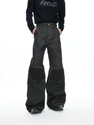 Front full body view of black gravel arc reinforced flare denim jeans with contrast topstitching and ribbed knee panels