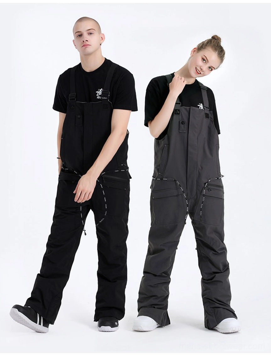 Gray and black unisex bib snow pants styled on two models with relaxed straight legs, drawstring waist details, and functional winter streetwear design