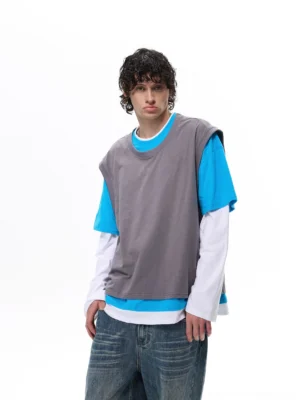 Front view of a gray blue and white faux layered vest tee top styled with loose washed blue jeans for a Korean streetwear outfit