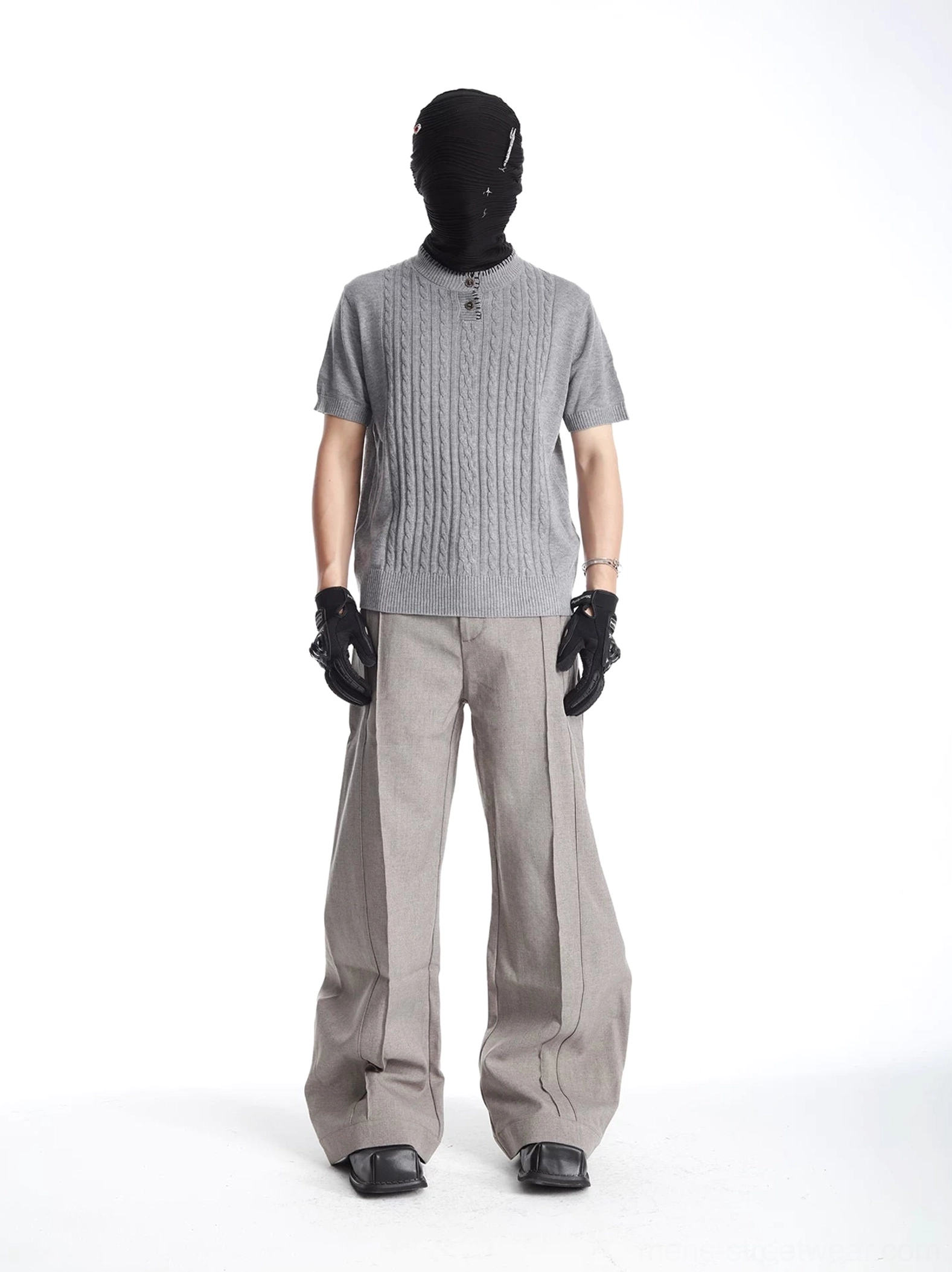 Full body styling image of gray cable knit Henley sweater tee paired with wide-leg trousers and leather shoes