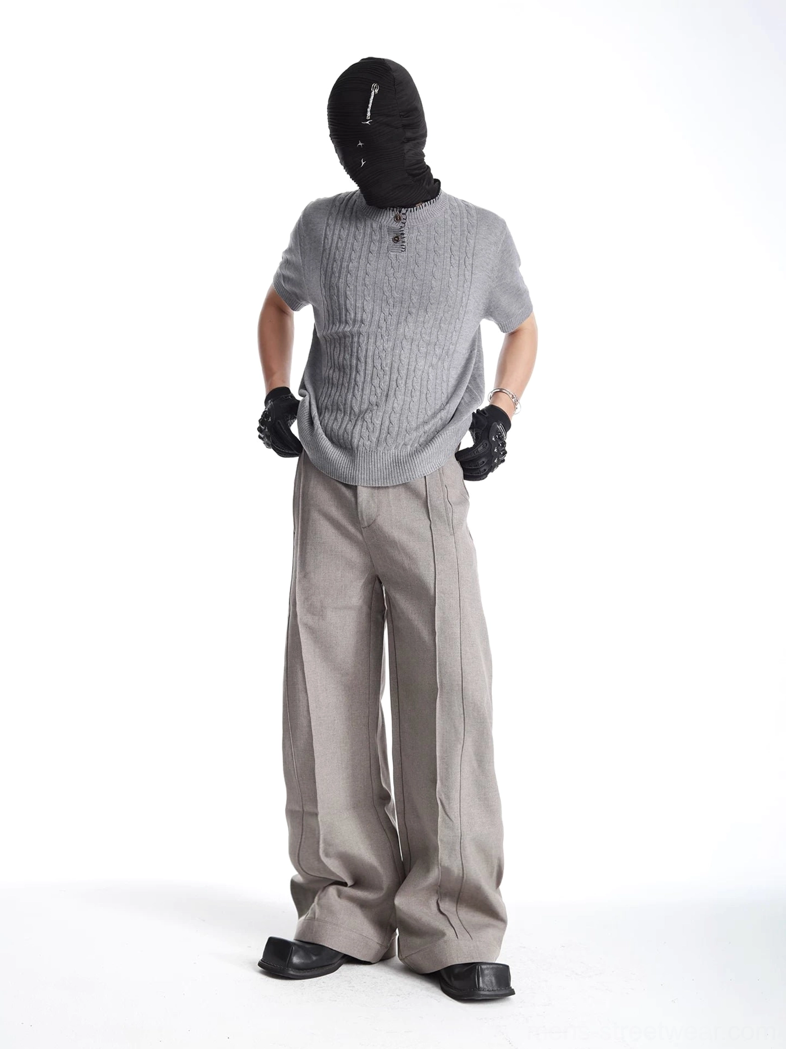 Side-front full body view of gray textured cable knit Henley short sleeve sweater tee in minimalist streetwear styling