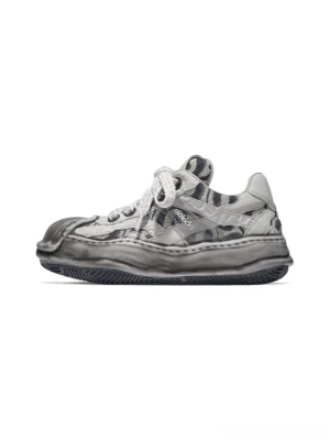 Light gray camouflage distressed shell toe leather skate sneaker shown in left side profile with thick twisted laces and weathered sculpted sole