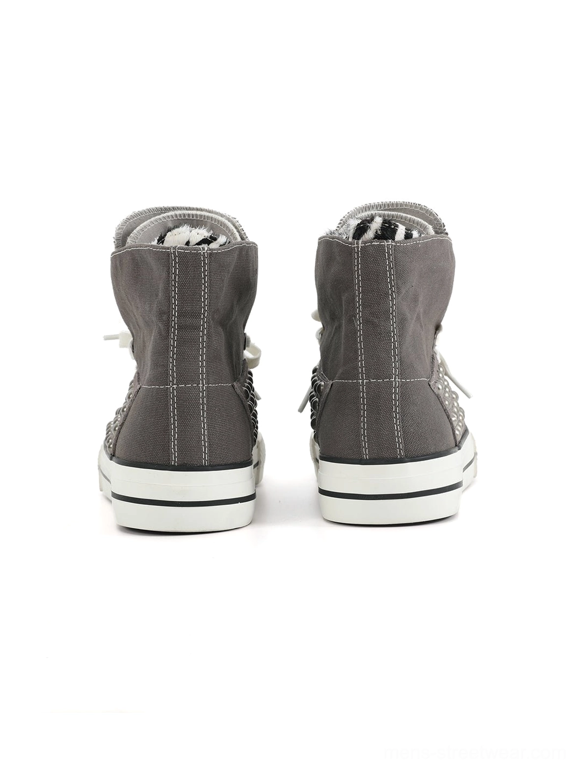 Rear view of gray canvas zebra studded high-top sneakers with white rubber midsoles, black trim, heel counters, and lace eyelets